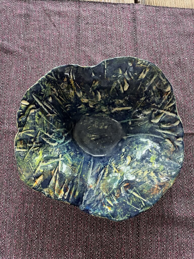 Serving dish painted with underglazes, stains, and covered with clear glaze to become safe for the food purpose